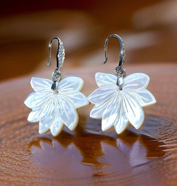 A pair of mother of pearl shell 'Lotus' shaped earrings with sterling silver hooks and cubic zircons adornment.