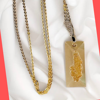 A Swarovski growing rectangle gold crystal necklace with a gold-plated sterling silver chain and bail.